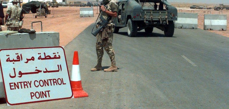 Soldier standing guard at a military base entry point